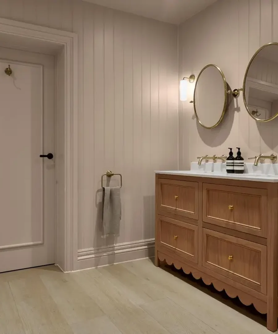 Room set of a bathroom cabinet and mirrors featuring whispering rose paint