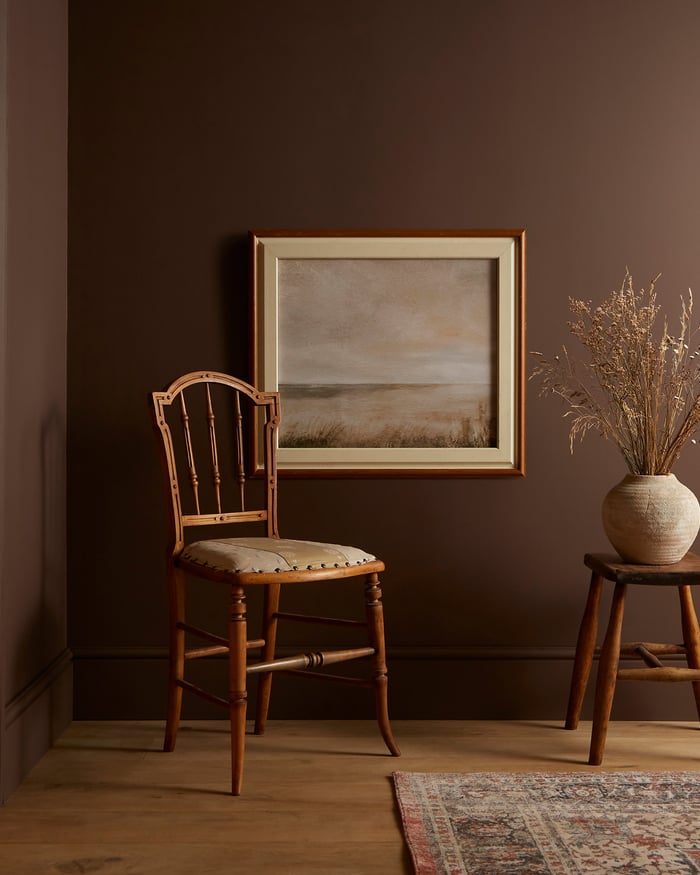 Roomset of corner of a room with chair and small table featuring Elderton paint