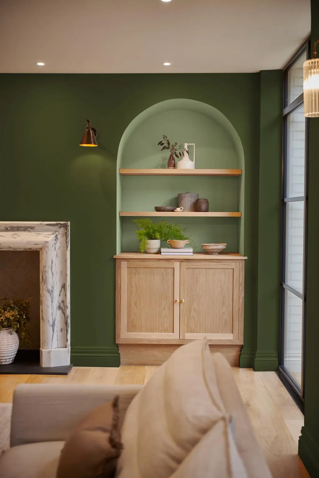 A roomset image including a sofa and alcove shelving featuring our Willow and Forest paint