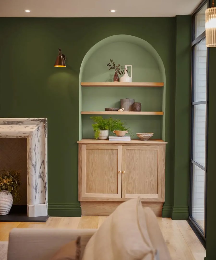 A roomset image including a sofa and alcove shelving featuring our Willow and Forest paint