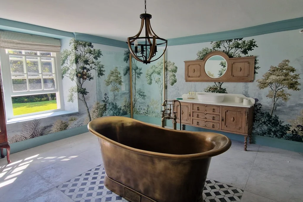 Grizedale Dawn in a customer's bathroom featuring a large copper bath in the centre of the room with wooden cabinetry and a wooden mirror