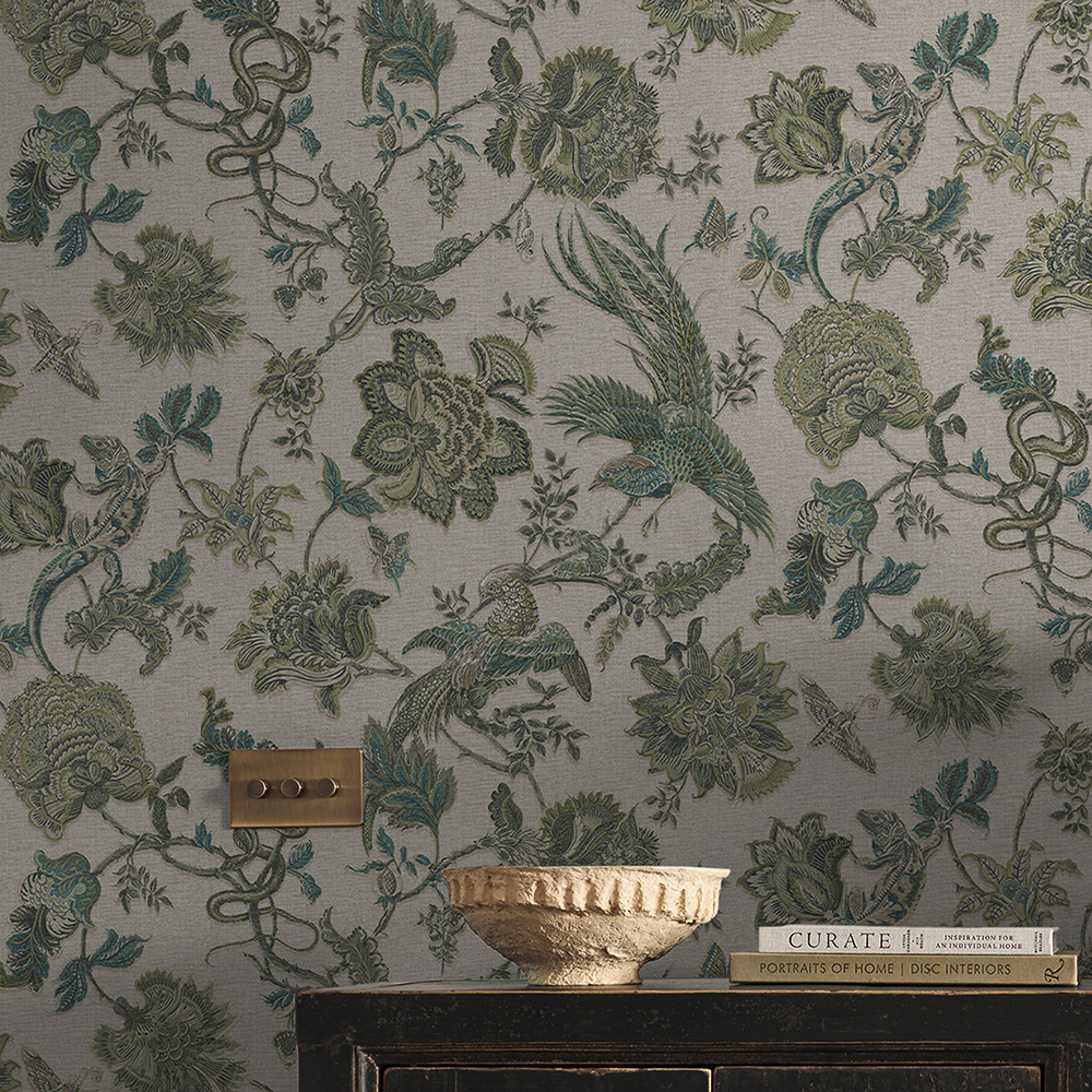 A small vase and books on a cabinet with Eternal Weave Sage wallpaper on the walls