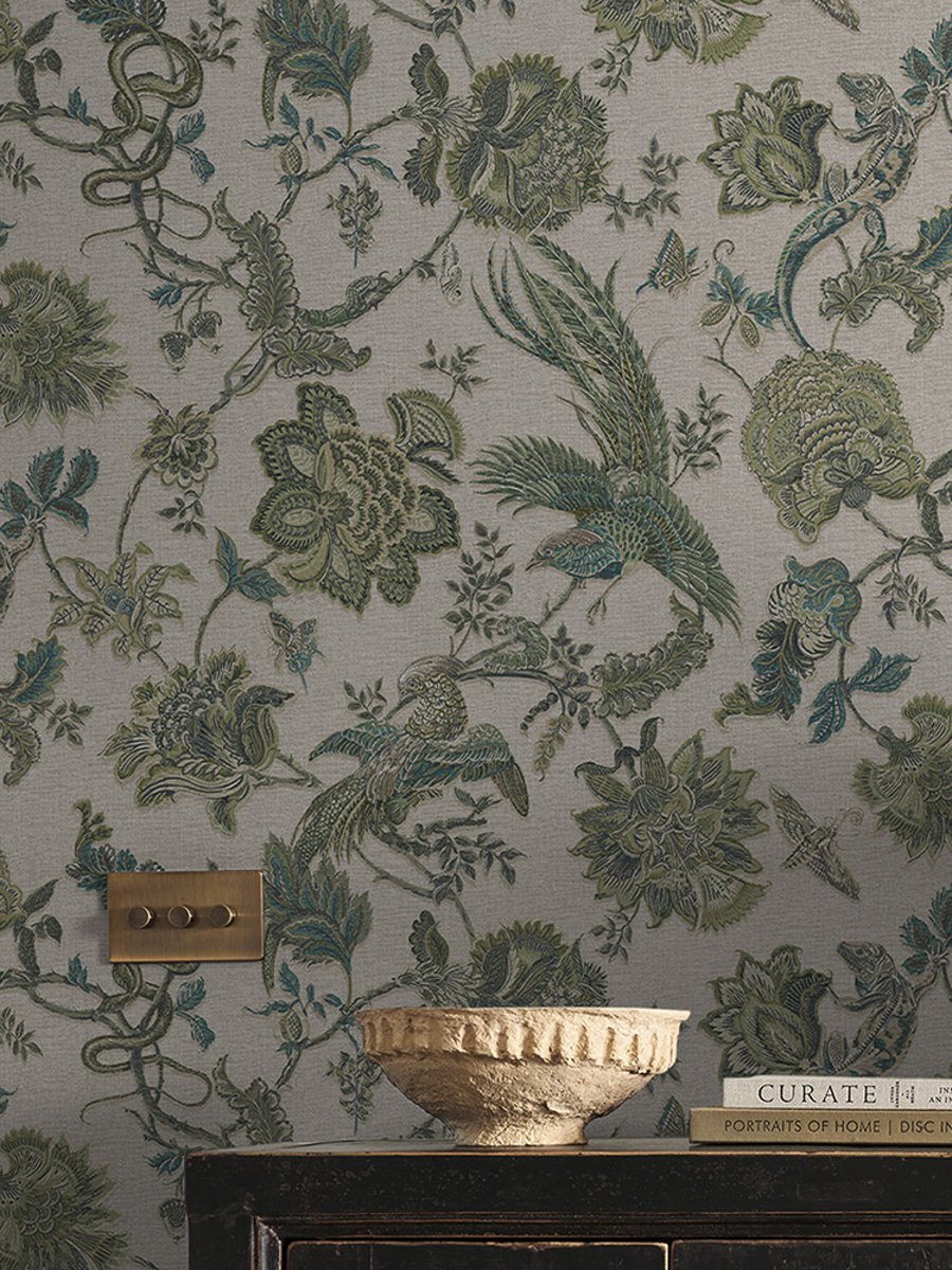 A small vase and books on a cabinet with Eternal Weave Sage wallpaper on the walls