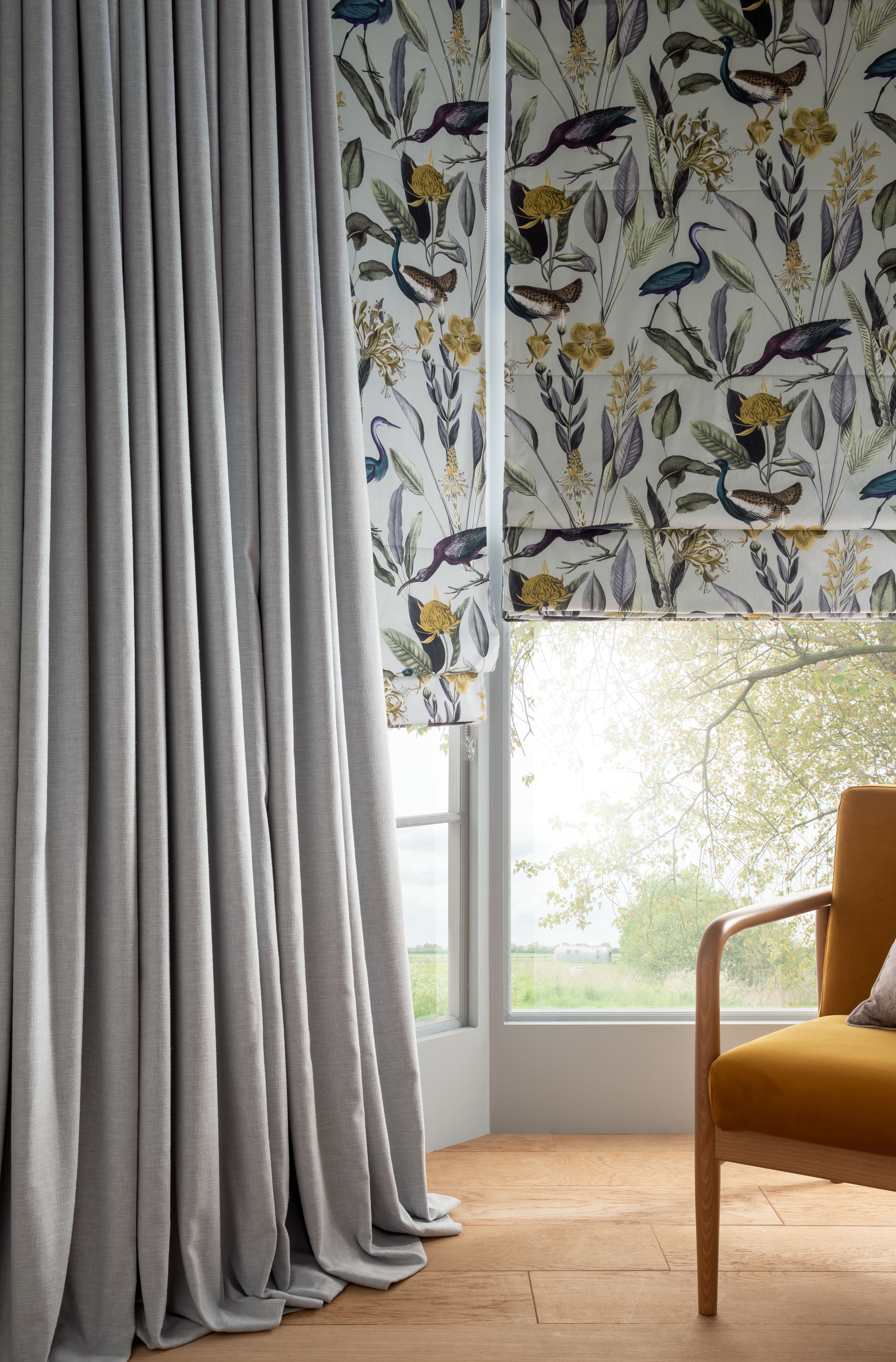 Glasshouse Grey blind and Wallace Grey curtains in living room setting