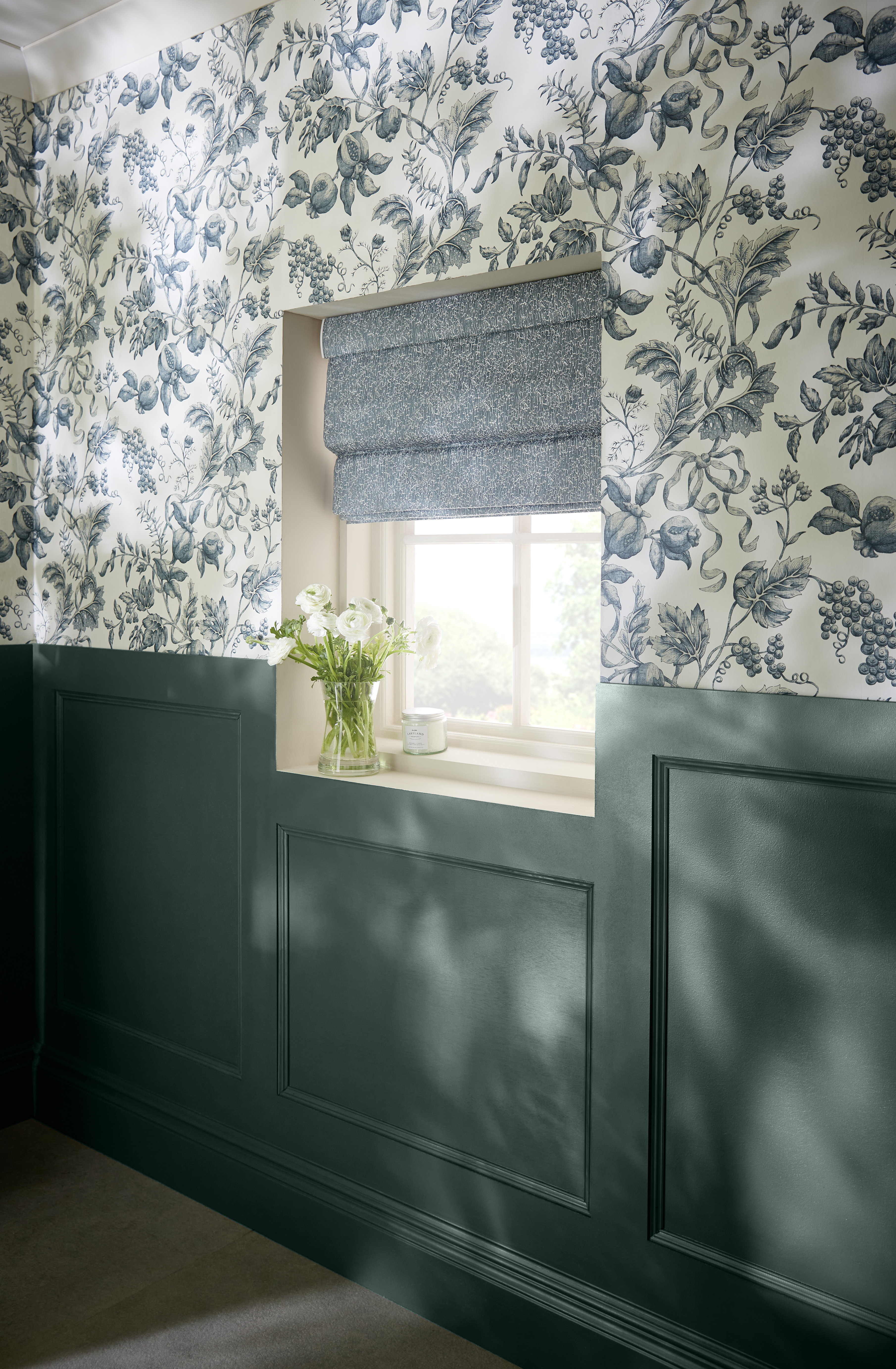 Roman Navy shade with coordinating wallpaper and paint in a hallway setting