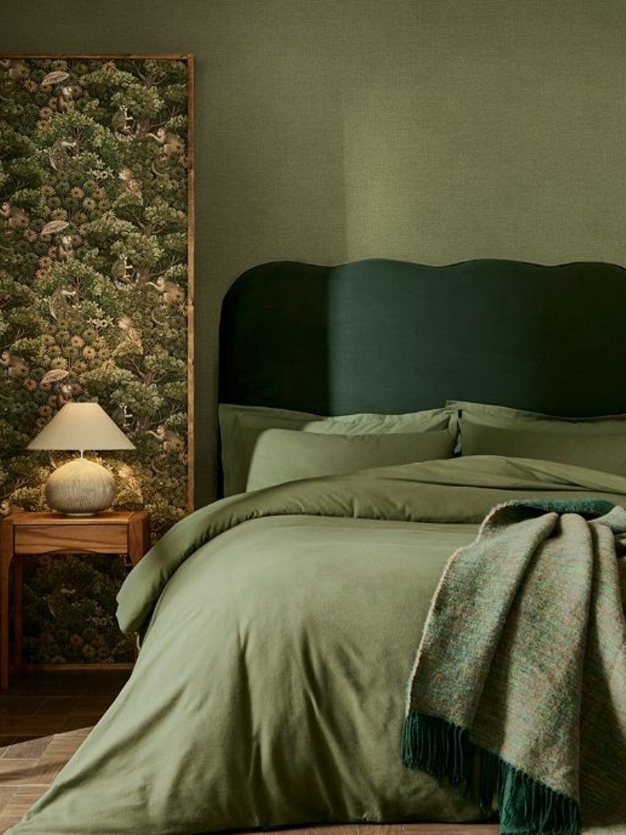 Treetop Troop Green Wallpaper coordinated with Haptic Olive in a bedroom setting