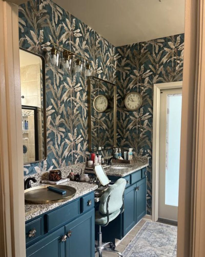 Borneo Midnight Wallpaper in a bathroom setting with dual sinks, matching rectangular mirrors and a feature wall light