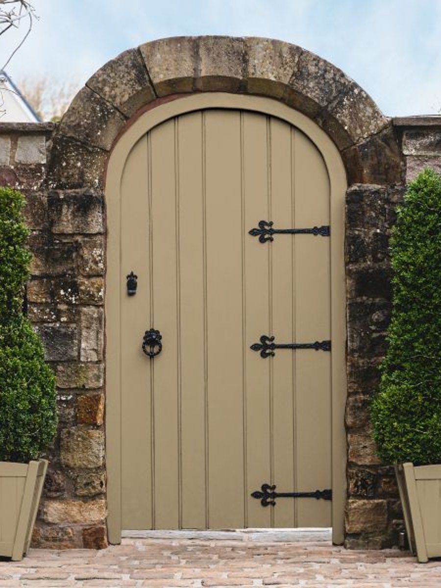 A garden gate with planters paint in Toasted Almond Exterior Paint