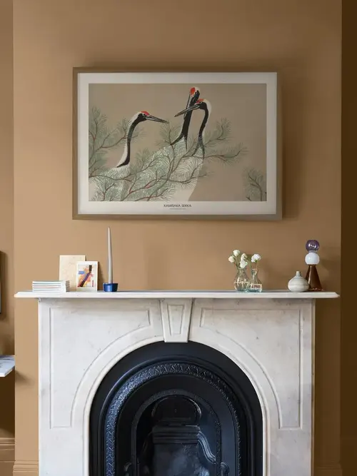 Image of roomset with fireplace and artwork above it featuring toasted teacake paint