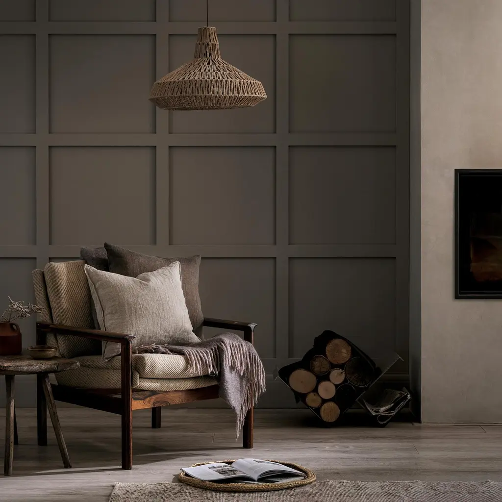 Panelled wall featuring warm baguette paint and a rocking chair with cushions