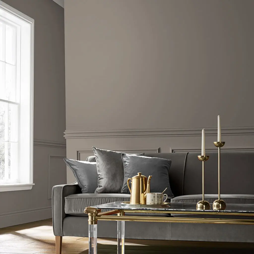 Room set featuring sofa, coffee tables with candles on and Guvnor paint
