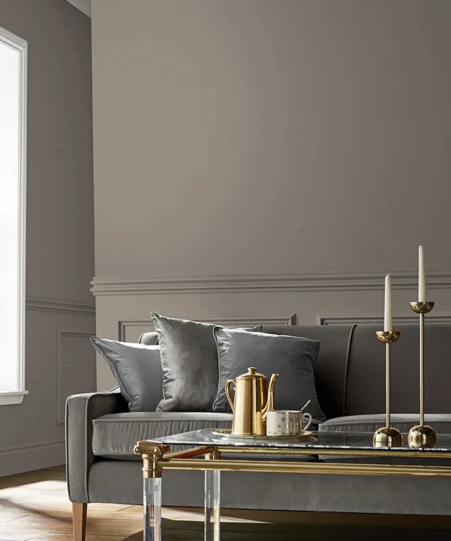 Room set featuring sofa, coffee tables with candles on and Guvnor paint
