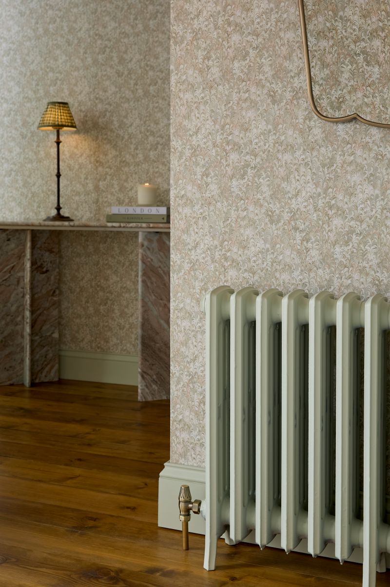 Soft Sage interior eggshell paint on a column radiator, styled with Marbre wallpaper for a calm, contemporary finish.