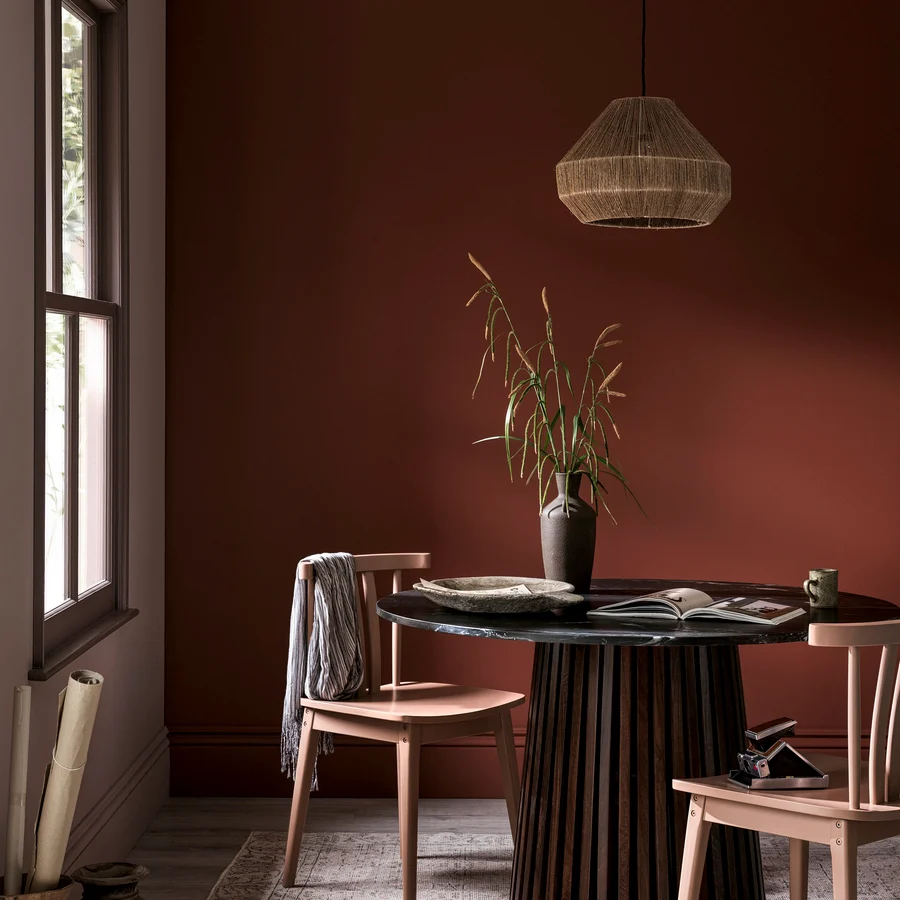 Dining room table and warming colour scheme on walls with Hot Mocha, Pimento, Elderton and Chesterfield paints.