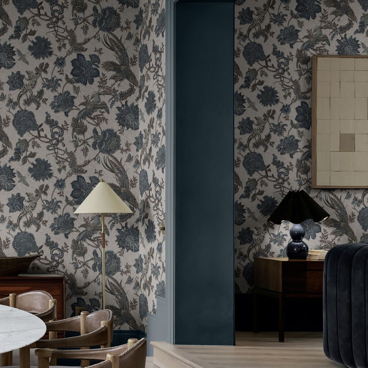 A dining room setting with Eternal Weave Denim wallpaper on the walls completed with minimal framed artwork