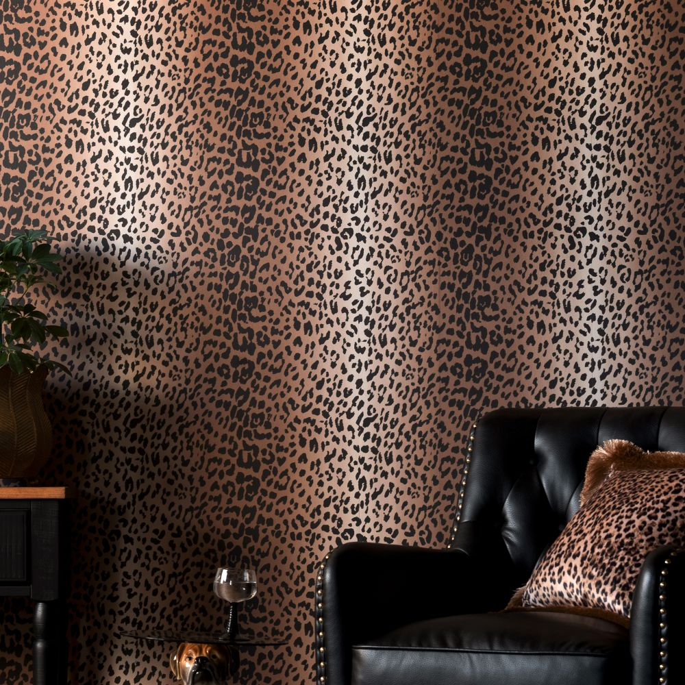 Rockett St George Wild at Heart Leopard Tan Wallpaper in a room with black chair and cushions