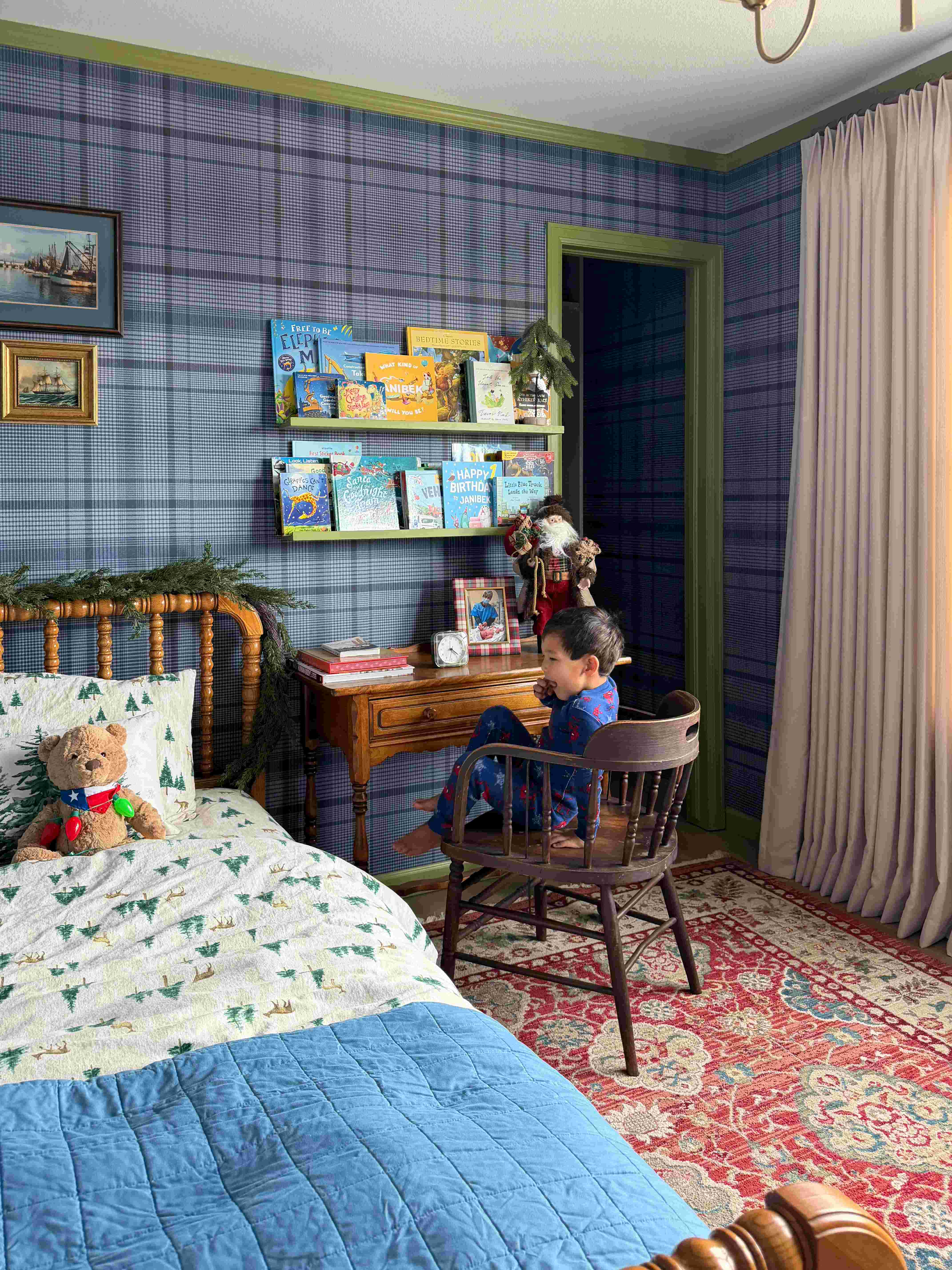 kids bedroom with bed, red rug and heritage blue plaid wallpaper