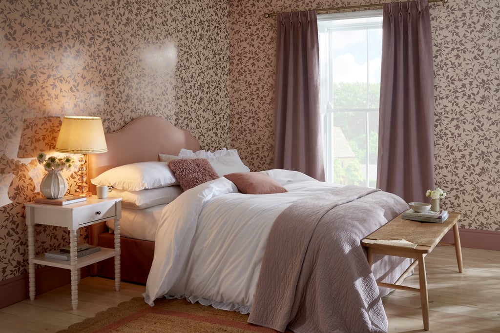 Midsummer Whispering Rose wallpaper in a bedroom setting with coordinating paint and soft furnishings
