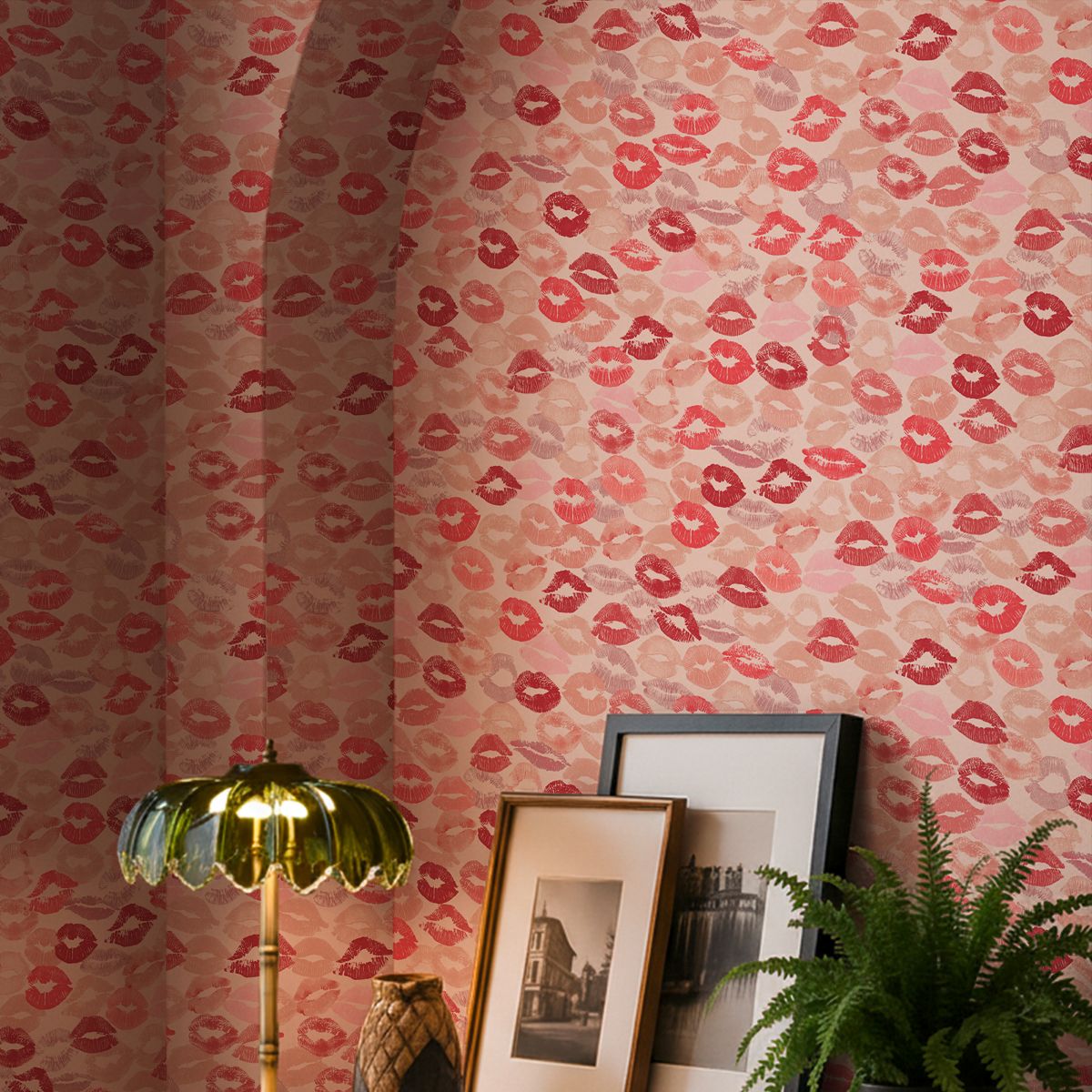 Rockett St George Kiss Me Lipstick Kisses Wallpaper in a room with framed pictures, a light and a plant.