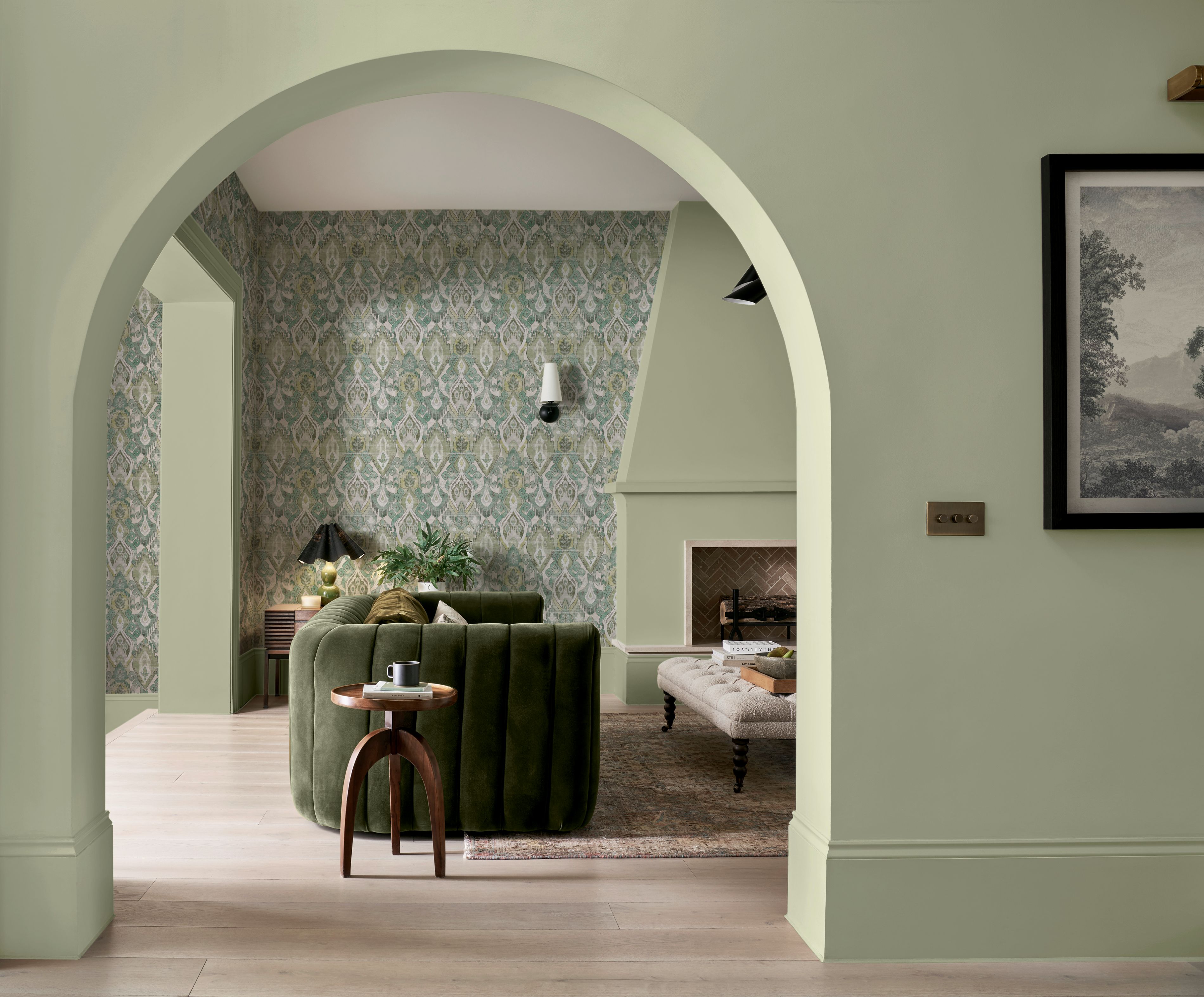 Daraee Tapestry Green wallpaper perfectly partnered with whirl paint in a living room setting