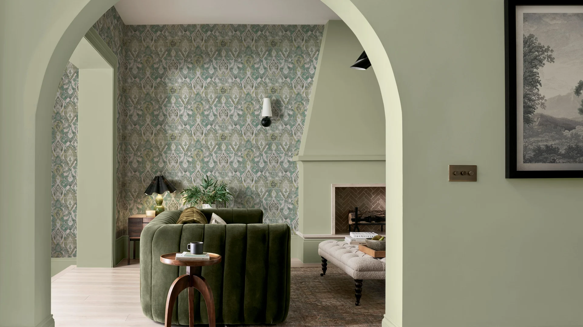 Daraee Tapestry Green wallpaper perfectly partnered with whirl paint in a living room setting