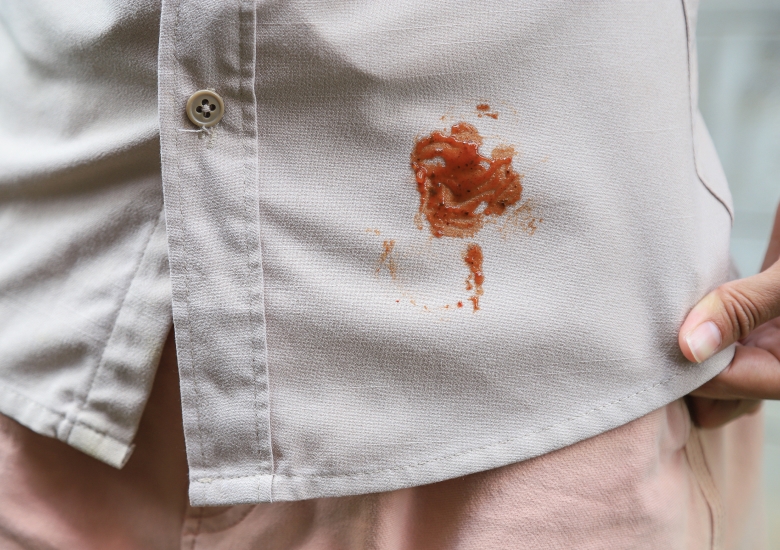 Tomato sauce stain on a white shirt