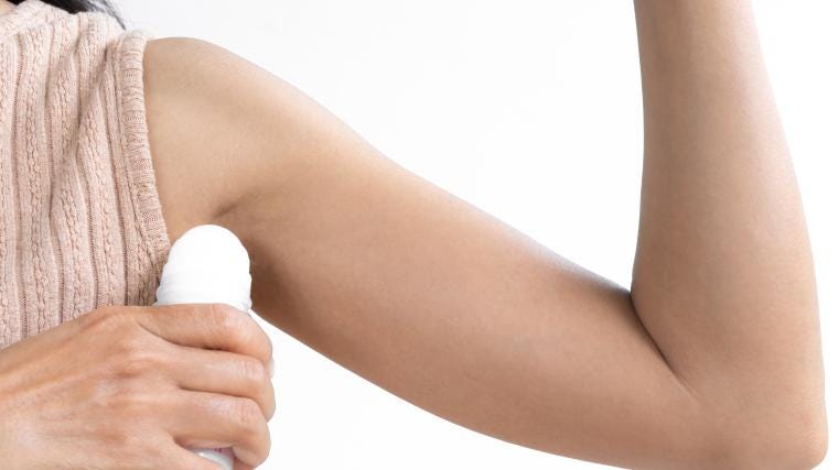 A person applying deodorant