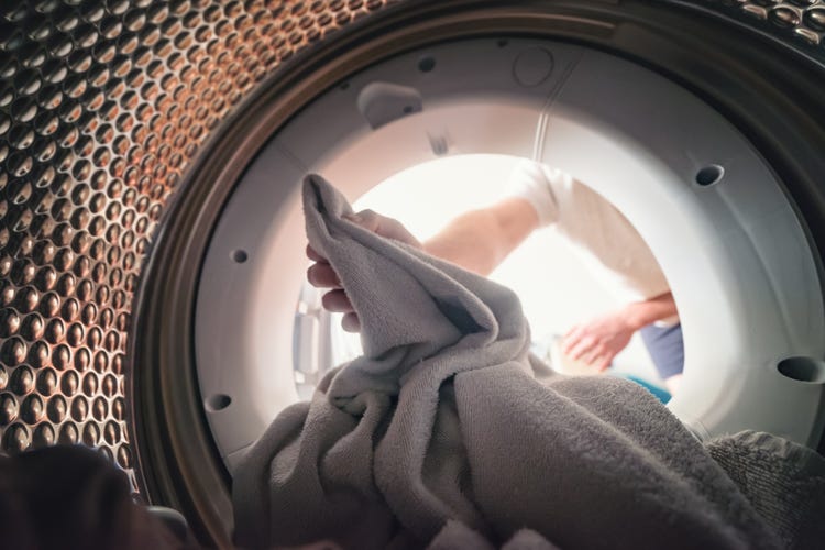 clothes into a washing machine