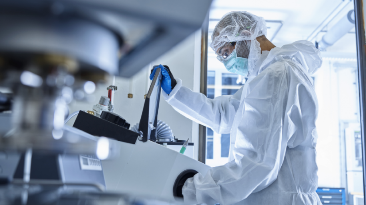 Scientist in protective gear working in a laboratory 