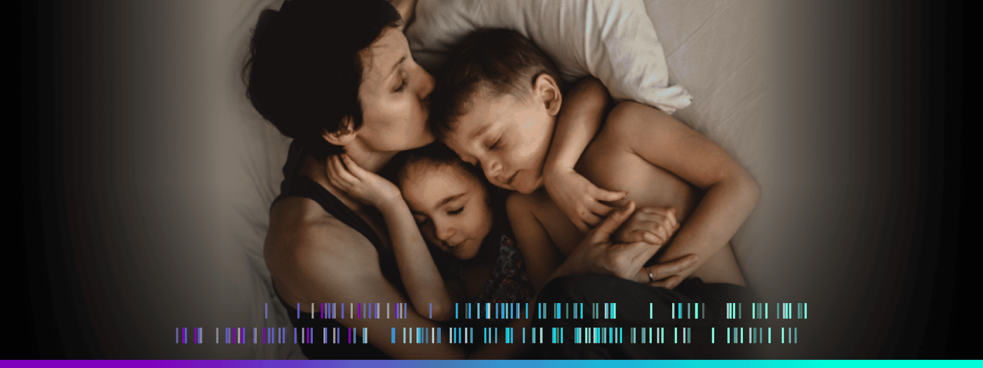 Mother hugging her son and daughter on a bed