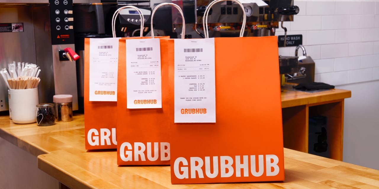 Grubhub food delivery bags on a counter Grubhub food delivery bags on a counter