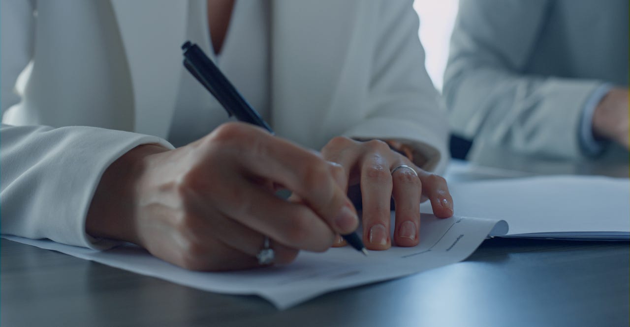 man signing paper man signing paper