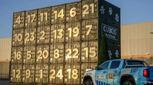 A stack of storage containers with a pickup truck next to it A stack of storage containers with a pickup truck next to it