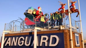 A large decoration of Santa in his sleigh with reindeer on a rooftop A large decoration of Santa in his sleigh with reindeer on a rooftop