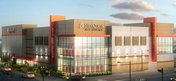 This StorQuest facility is in Denver. In this high-density, lot-line to lot-line development, all driveways, parking and loading areas are contained within the building envelope, with storage stacked on floors above. Customer vehicle access is provided by an extra-wide security grill at ground level. (Courtesy of DCB Construction)
