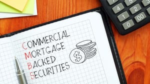 An image of a calculator and a notebook with the words commercial mortgage back security An image of a calculator and a notebook with the words commercial mortgage back security
