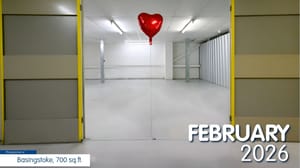 An open self-storage unit with a red balloon floating inside it An open self-storage unit with a red balloon floating inside it