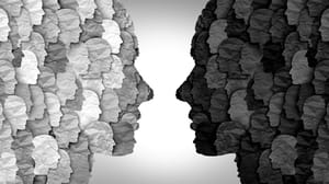 A side view of two paper heads composed of smaller paper heads looking at each other A side view of two paper heads composed of smaller paper heads looking at each other