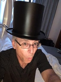 My hotel room had a hanging lamp in the shape of a top hat. I'm probably not the first person to take a selfie with it.