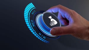 A hand turning a dial to high for raising money A hand turning a dial to high for raising money