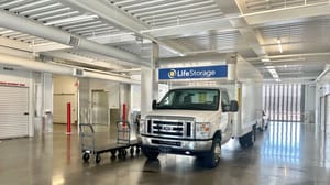 A small truck parked inside a self-storage facility A small truck parked inside a self-storage facility