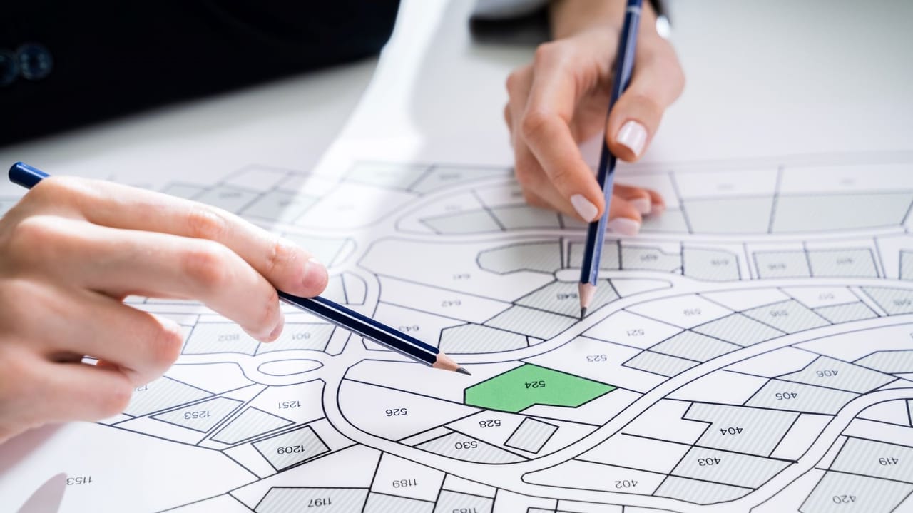 Two hands on a map to choose a site on which to build self-storage Two hands on a map to choose a site on which to build self-storage