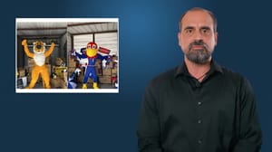 A man talking on screen with a graphic over his right shoulder A man talking on screen with a graphic over his right shoulder