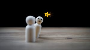 An image of two white stick figures with a star with the number five over one's head An image of two white stick figures with a star with the number five over one's head