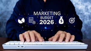 An image of a person at a laptop with the words mareketing budget 2026 hovering above his hands An image of a person at a laptop with the words mareketing budget 2026 hovering above his hands
