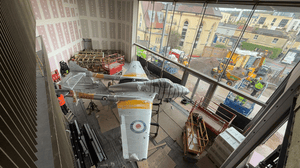 An old airplane hanging from the ceiling inside a self-storage building An old airplane hanging from the ceiling inside a self-storage building