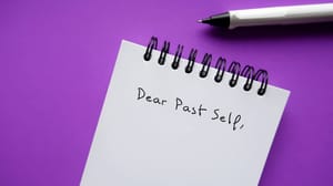 A page in a spiral notebook that says Note to past self A page in a spiral notebook that says Note to past self