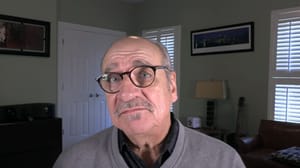 A man looking while speaking into a camera A man looking while speaking into a camera