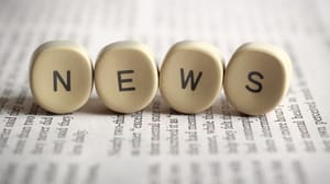 The word news with each letter in a round wood block The word news with each letter in a round wood block