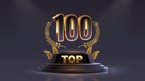 An image of the number 100 with the word top under it on top of a pedestal An image of the number 100 with the word top under it on top of a pedestal